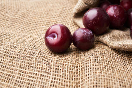 plums fruits natural products on a wooden table top viewの写真素材
