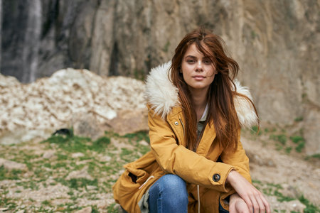woman yellow jacket tourism mountains adventure landscape