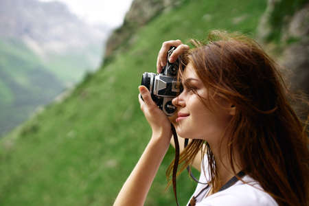 Woman photographer on nature landscape mountains travelの写真素材