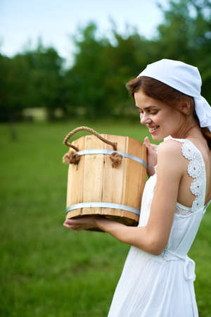 Woman in white dress in the village outdoors Green grass Farmerの写真素材