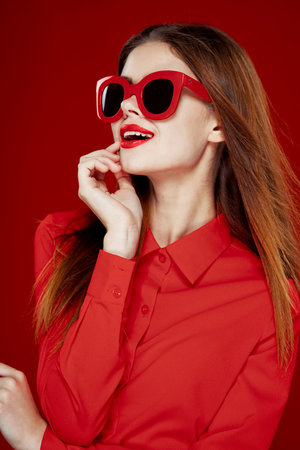 cheerful woman in a red shirt sunglasses Glamor close-up
