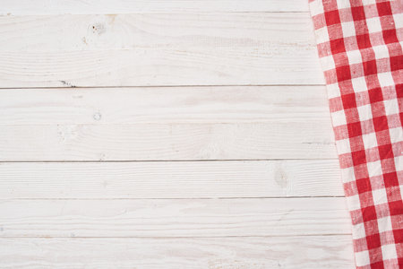 Red checkered tablecloth wooden background texture kitchen decorationの写真素材