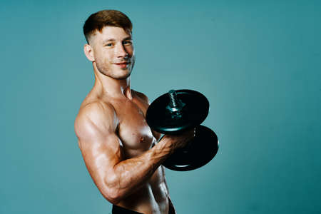 bodybuilder with a muscular body with dumbbells in his hands fitnessの写真素材
