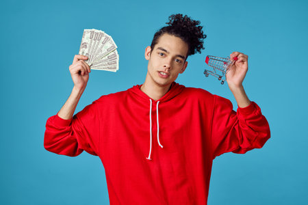 curly guy in a red sweater posing fashion modern hipster styleの写真素材