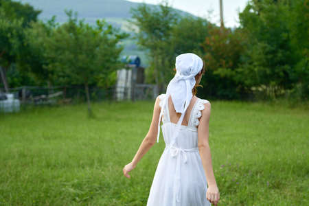 Woman in white dress countryside village nature ecologyの写真素材