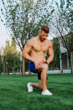 male athlete with pumped up body in parks crossfit workout