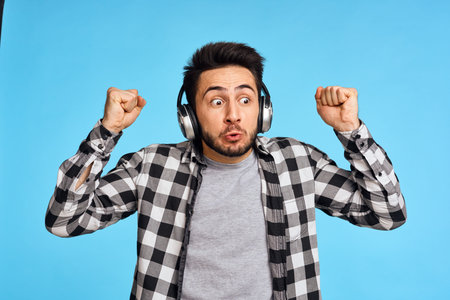 emotional bearded man listening to music with headphones technology