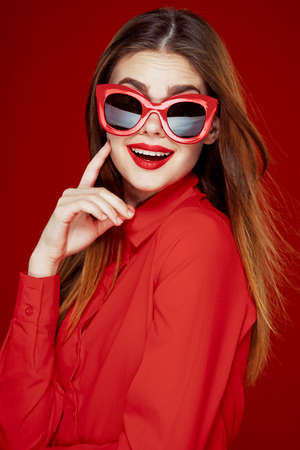 cheerful woman in a red shirt sunglasses Glamor close-upの写真素材