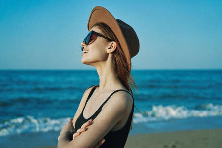 woman in a hat sunglasses by the ocean travel sunの写真素材
