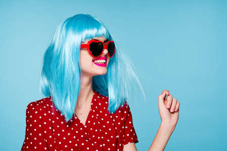 glamorous woman purple hair posing sunglasses blue backgroundの写真素材