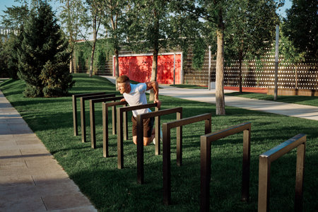 athletic man with dumbbells outdoors at CrossFit park