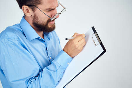 bearded man in blue shirt documents manager professionalの写真素材