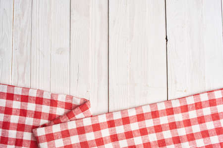 Red checkered tablecloth wooden background texture kitchen decorationの写真素材