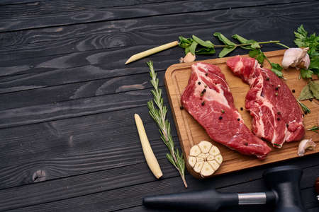meat on wooden board vegetables and ingredients for cooking wooden backgroundの写真素材