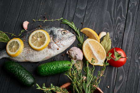 fish on wooden board ingredients lemon fresh food sea foodの写真素材