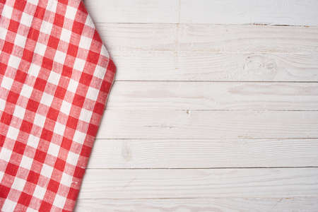 Red checkered tablecloth wooden background texture kitchen decorationの写真素材