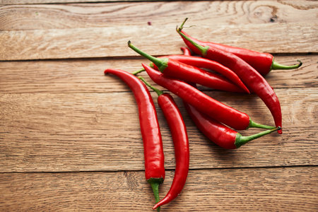 red hot chili peppers on a wooden board kitchen ingredientsの写真素材