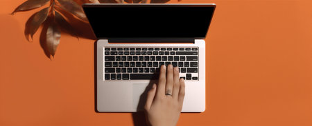 hand keyboard palm leaf laptop top computer background business orange office. Generative AI.の素材