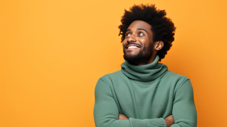 Happy young black man with a cheerful smile posing in a studio.の素材