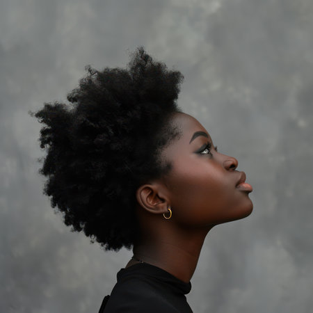 Serene Elegance: Portrait of a Pretty African American Woman with Curly Afro Hair, Confident and Calm, Posing Alone against a Clear Backgroundの素材