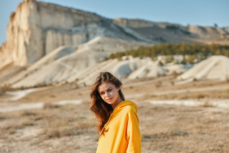 Golden beauty standing in awe of majestic mountain and rock formationの写真素材