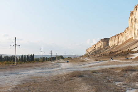 Scenic mountain road under clear blue sky on a sunny dayの写真素材