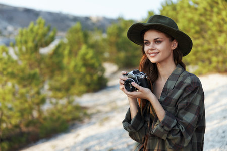 vintage camera adventures woman in plaid shirt explores the forest with old cameraの写真素材