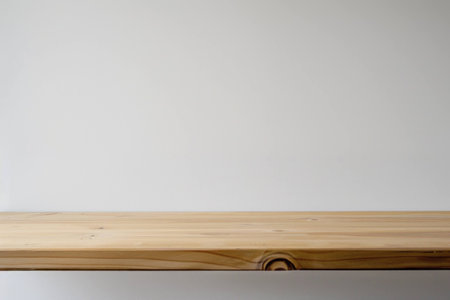 Minimalistic wooden table surface on a plain white background, perfect for showcasing products or in interior design contexts. Modern and clean aesthetic.の素材