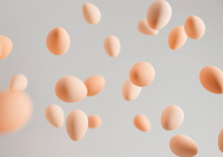 Aesthetic composition of flying eggs in a light gray background, symbolizing food, freshness, and cooking inspiration. Concept of creativity in food design.の素材