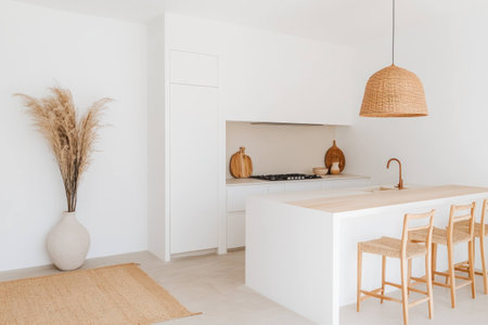 Cozy modern kitchen with neutral tones, featuring a beautiful arrangement of decorative pumpkins, a stylish rattan light fixture, and elegant decor elementsの素材