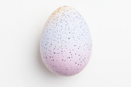 Pastel colored speckled egg on a light background, perfect for spring seasonal decoration, Easter themes, and creative projectsの素材