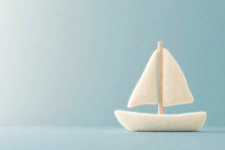 Soft white sailboat model on a calm blue background, symbolizing tranquility, adventure, and creativity for fresh ideas and inspirationの素材