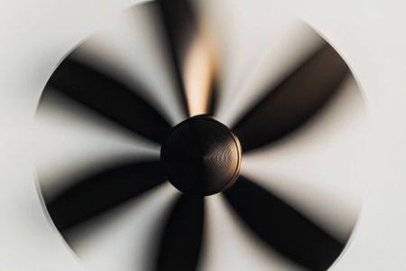 Abstract motion blur of a ceiling fan illustrating movement and energy in a modern interior design, creating a dynamic and calm atmosphereの素材