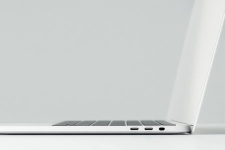 Sleek white laptop on minimalistic background, showcasing modern design and technology, perfect for workspace aesthetics and online creativityの素材