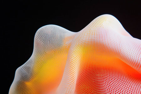 Abstract mesh fabric creating a colorful wave effect, emphasizing softness and texture against a dark background, ideal for modern design conceptsの素材
