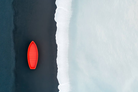 A striking red boat resting on a dark beach, contrasting with the white waves, evoking tranquility and solitude in nature s beautyの素材