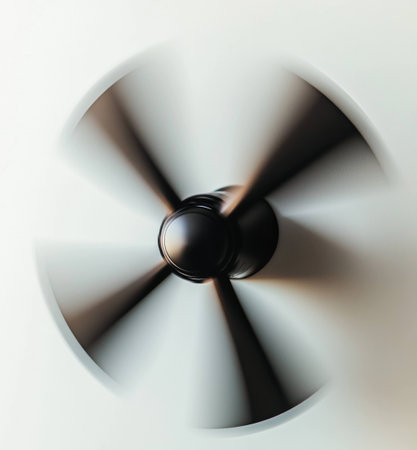 A dynamic image of a black ceiling fan rotating, embodying modern design and conveying a sense of movement and airflow in a minimalist spaceの素材
