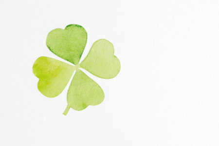 Green watercolor shamrock illustration symbolizing luck and St Patrick s Day, featuring a light and fresh color palette on a white backgroundの素材