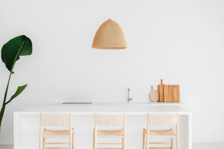 Modern minimalist kitchen interior featuring wooden accents, bright white walls, and a relaxed atmosphere for contemporary lifestyle inspirationの素材
