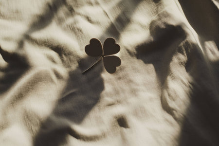 Heart shaped clover plant on soft fabric background, symbolizing love and good luck, perfect for cozy home decor and seasonal inspirationの素材