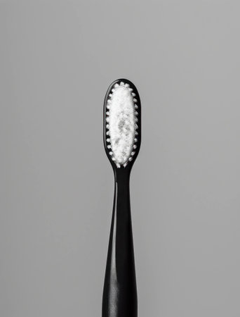 Minimalist black toothbrush on a gray background, ideal for dental hygiene and modern bathroom aesthetics Perfect for promoting oral care and health productsの素材