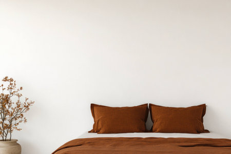 Cozy modern bedroom with brown bedding, neutral walls, and a minimalist decor for a warm and inviting atmosphere year roundの素材