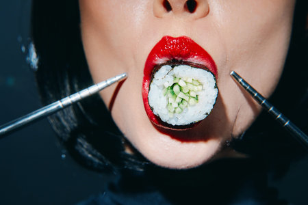 Bold sushi portrait of a woman with red lips holding sushi with chopsticks, showcasing a dramatic...