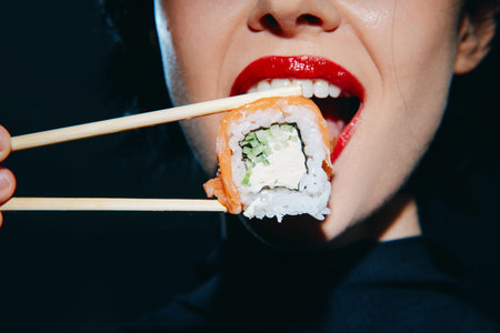 Woman enjoying sushi with chopsticks close-up, vibrant colors and bold emotions, perfect for food...