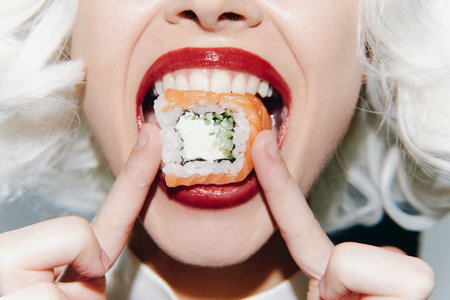 Close-up portrait of a model enjoying sushi with a vibrant expression, showcasing creative food art...