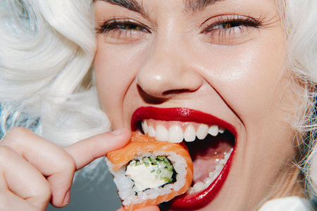 Stylish model enjoying sushi, showcasing vibrant colors and playful emotions in a modern setting, embodying a lively culinary experience with trendy fashion.の写真素材