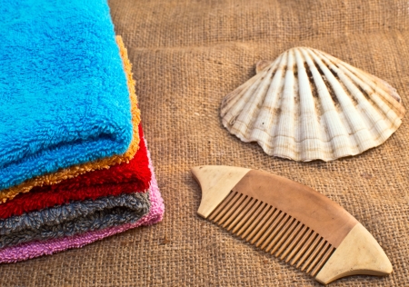 spa bath towels and sea shell on sacking burlapの写真素材