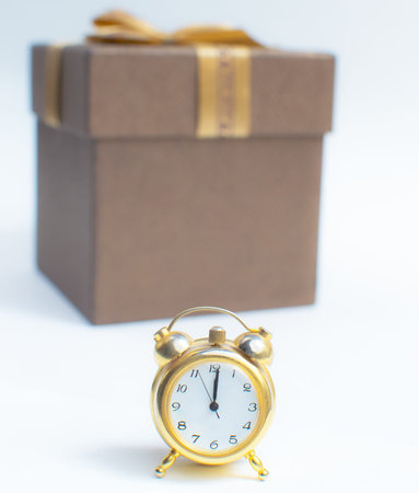 A Happy New Year Clock Striking Midnight with present gift box