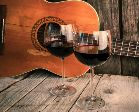 guitar and Wine on a wooden table romantic dinner backgroundの写真素材
