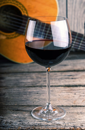 guitar and Wine on a wooden tableの写真素材